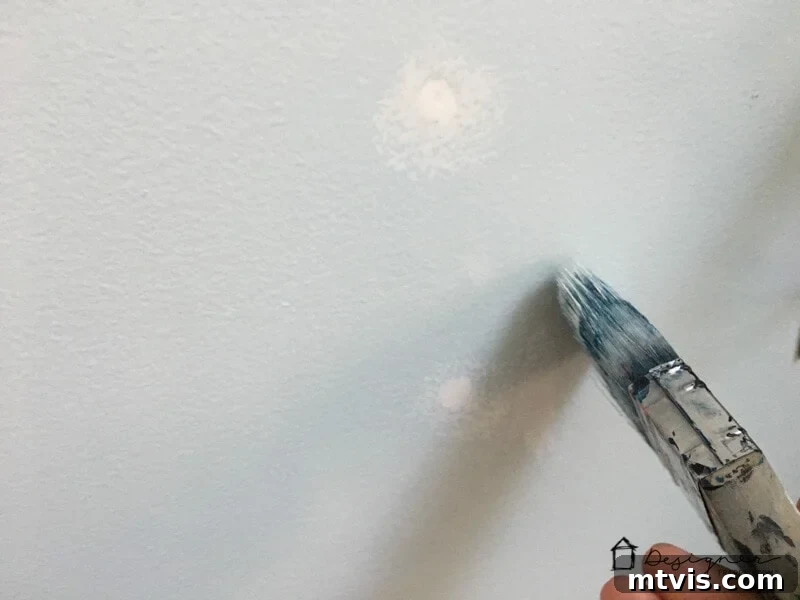How to Repair Drywall: Tips for Minor Repairs 5 touching up paint after drywall repair