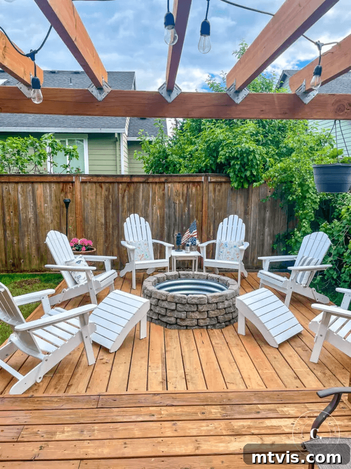 From Cozy Corners to Grand Gatherings: Fire Pit Ideas for All Spaces 14 A brilliant DIY fire pit idea featuring a floating deck with a galvanized steel fire ring, beautifully topped by a pergola adorned with enchanting lights, creating a captivating outdoor ambiance.