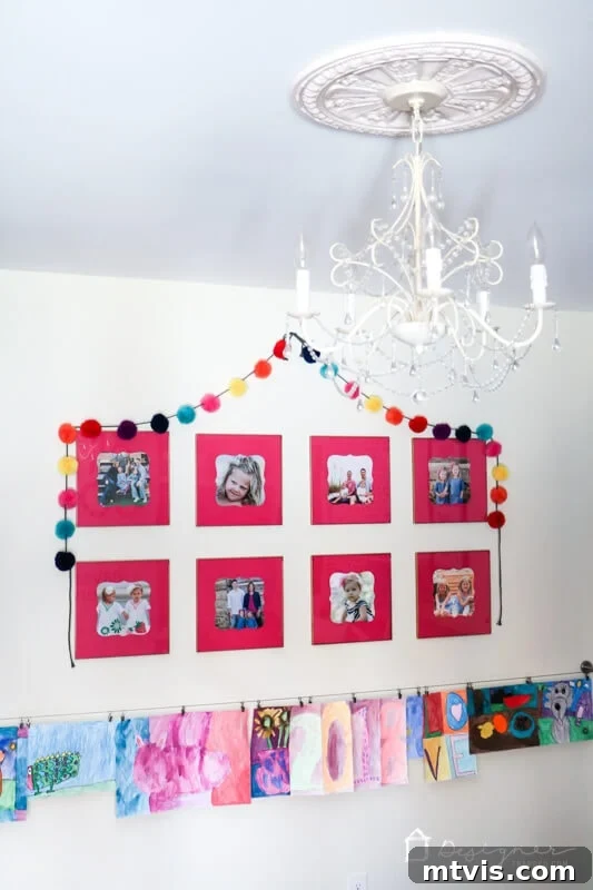 Craft Custom Photo Mats for Pennies 8 A beautifully arranged gallery wall in Attley's room, featuring multiple white frames with pink DIY picture mats and family photos.