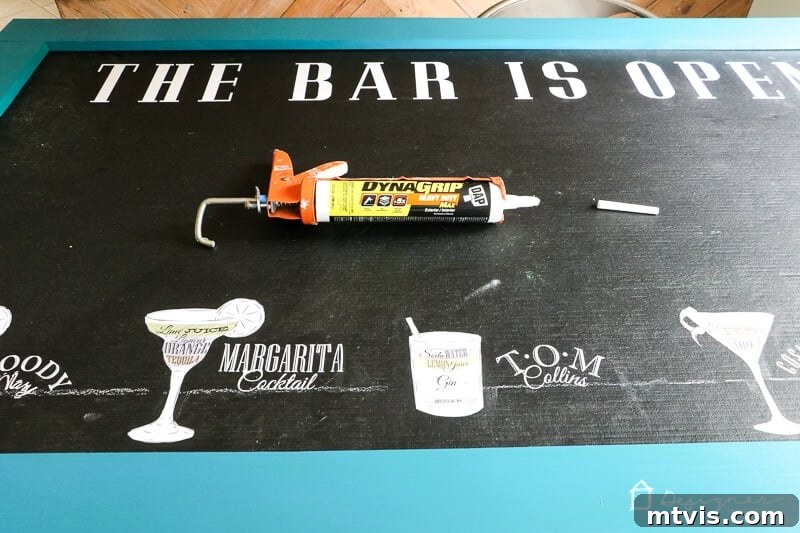 Clamping the wooden frame to the chalkboard as the adhesive cures.