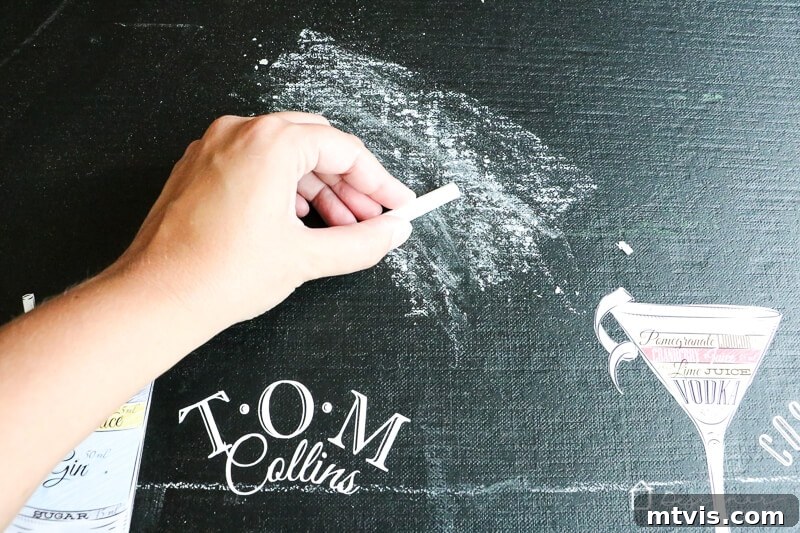 Seasoning the new outdoor chalkboard by rubbing chalk over the entire surface.