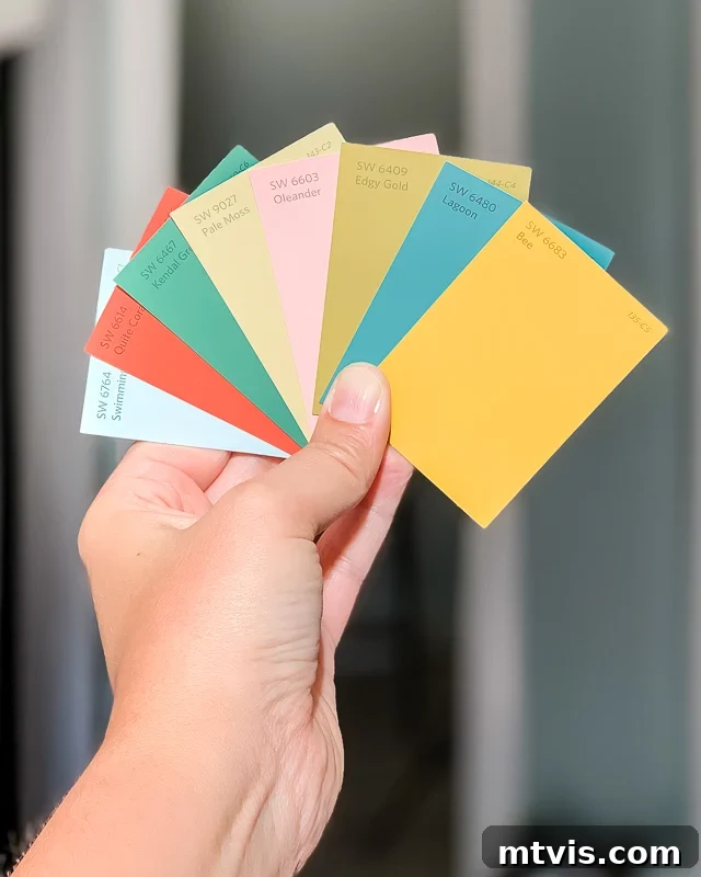 Unlock Your Home's Perfect Palette: Easy Paint Color Selection 2 Woman holding a variety of paint chip samples, demonstrating how to choose paint colors for a home.
