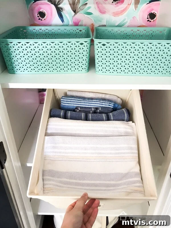 Smart Solutions for a Perfectly Organized Linen Closet 10 photo of towels stored in canvas bins to help keep linen closet organized