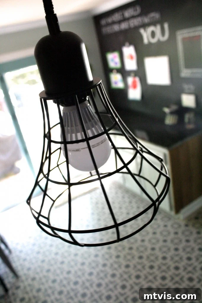 Industrial pendant lights over the kitchen island, a key design feature in the budget makeover.