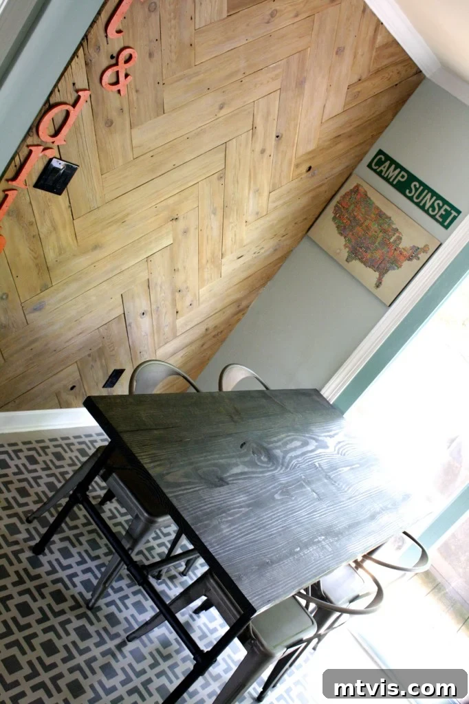 Close-up of the DIY industrial pipe table and metal chairs in the newly designed eat-in kitchen.