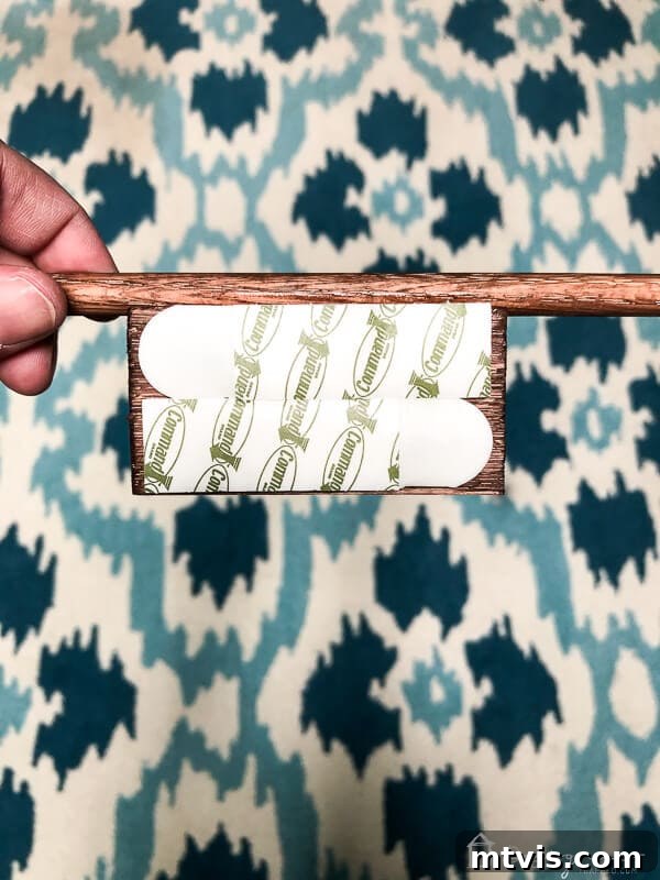Sparkle and Store: DIY Jewelry Organizers for Every Piece 12 Command picture hanging strips applied to the back of a wood block