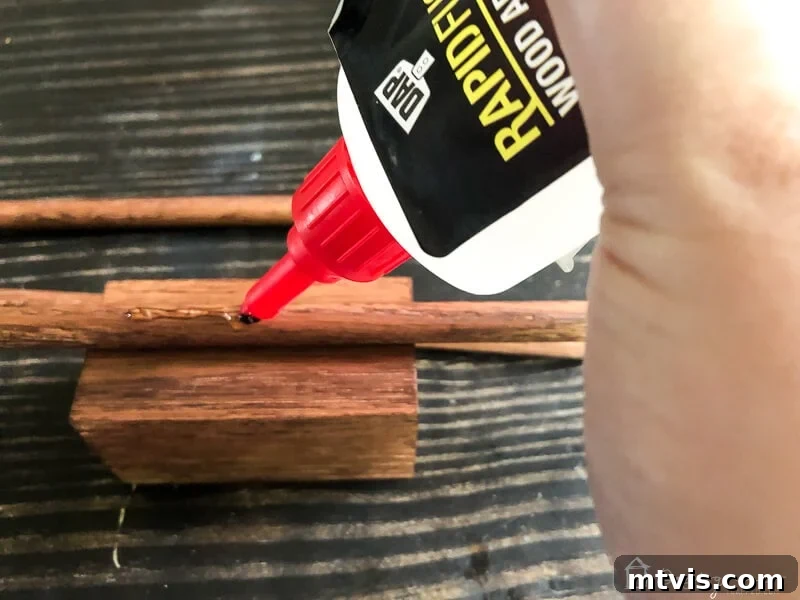 Sparkle and Store: DIY Jewelry Organizers for Every Piece 10 Applying DAP Rapid Fuse to a wood dowel before attaching to a block