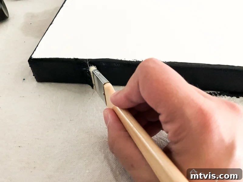 Effortless DIY Abstract Art Canvas 4 Painting the edges of a canvas in navy blue