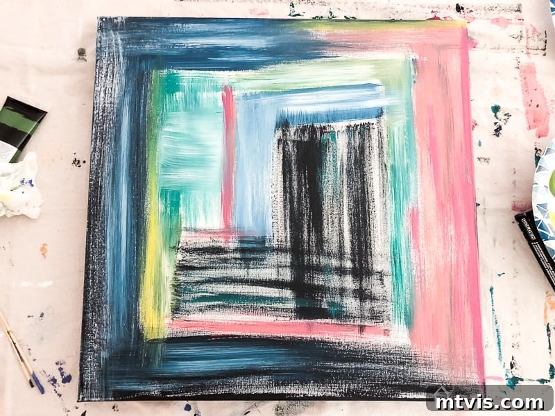 Effortless DIY Abstract Art Canvas 6 Abstract canvas filled with colors and textures, drying