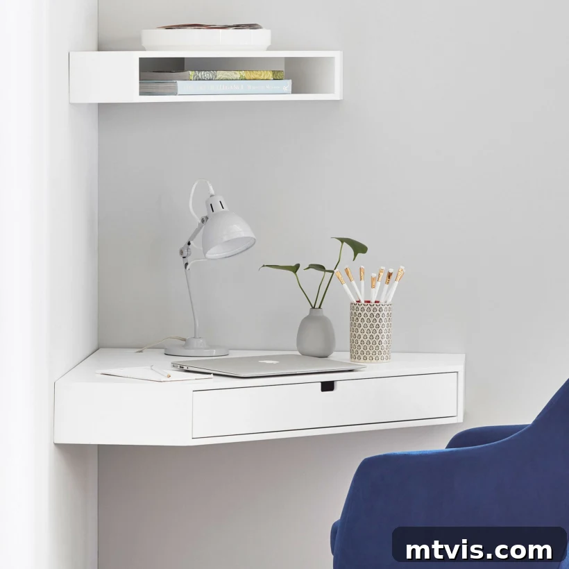 L-Shaped and Corner Desks: Build Your Own or Buy 6 A small white mounted corner desk has a drawer, a laptop, a lamp, a small plant, and a pencil cup. A small shelf above it holds a few books.