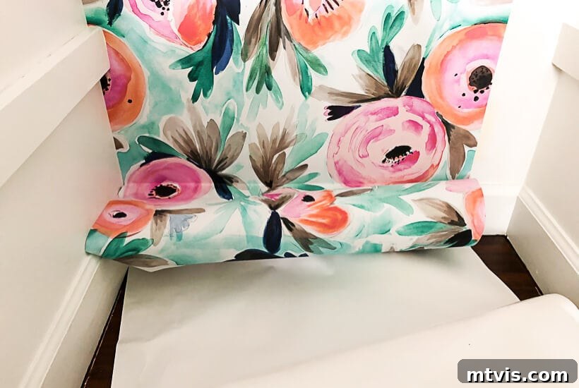 5 Steps to Perfectly Install Removable Wallpaper 2 Installing colorful removable wallpaper in a closet, showcasing a vibrant floral pattern on a blue background, transforming a simple space into a focal point.