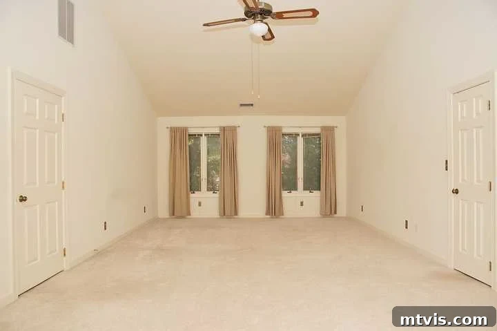 Our Blush and Indigo Sanctuary Unveiling 2 Old master bedroom before renovation - beige walls and simple decor with a tiny ceiling fan