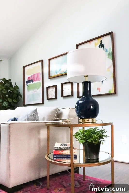 Our Blush and Indigo Sanctuary Unveiling 7 Close up of the pink and navy master bedroom sitting area, highlighting the sofa, tables, and decor accents