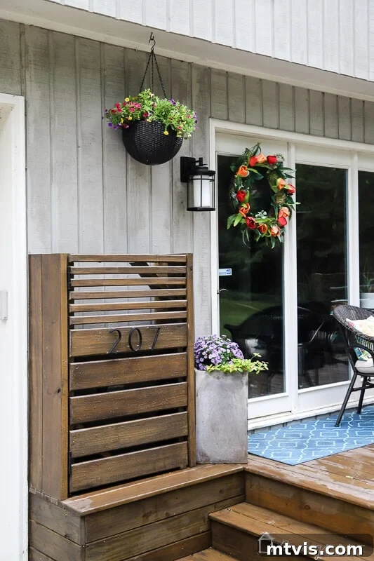 Modern DIY utility box cover with a stylish wooden gate door installed outside a contemporary home, blending functionality with aesthetic appeal.