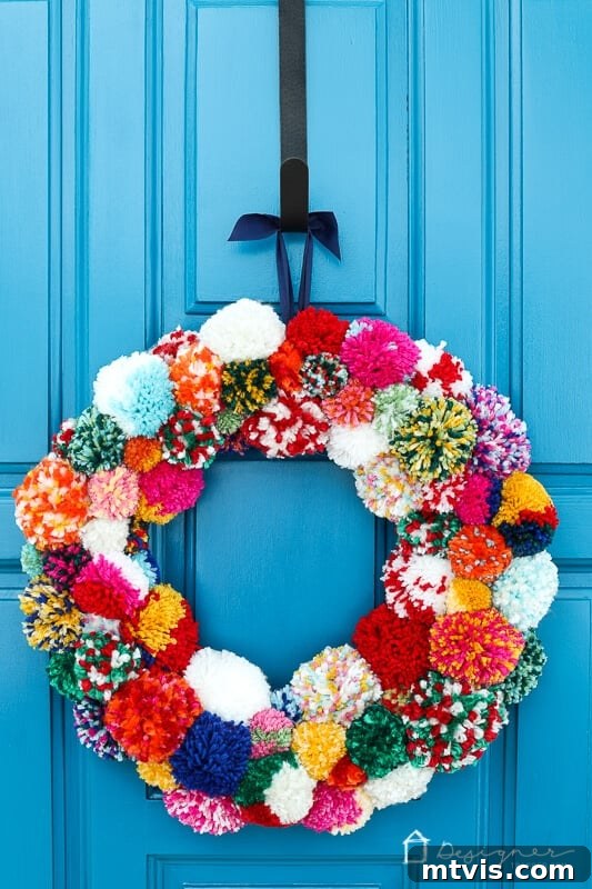 Fluffy Pom Pom Wreath Craft 2 Vibrant DIY pom pom wreath adding a burst of color to home decor