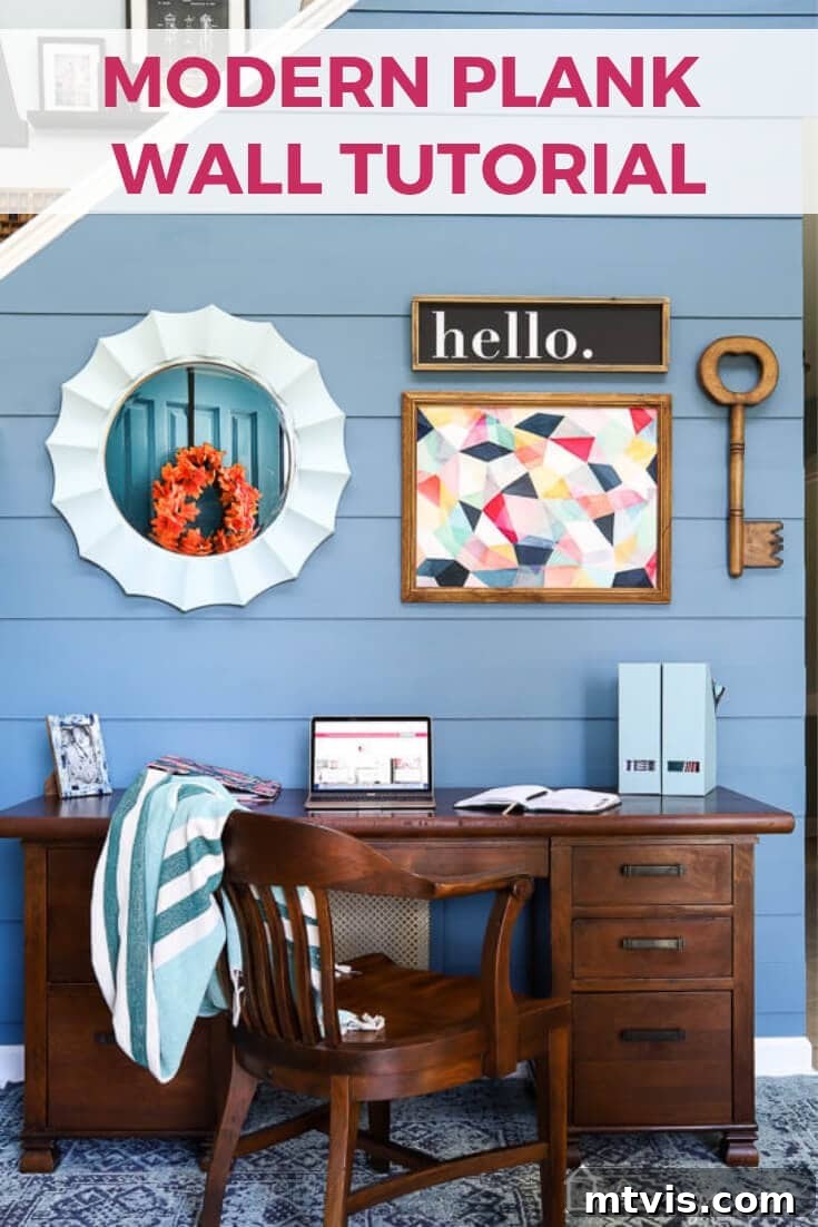 Stunning modern DIY plank wall painted in Behr Blueprint, transforming a foyer into a contemporary and functional space.