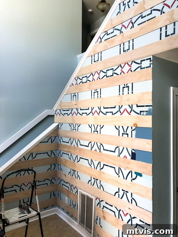 Modern plank wall installation in progress, showing several rows already secured.