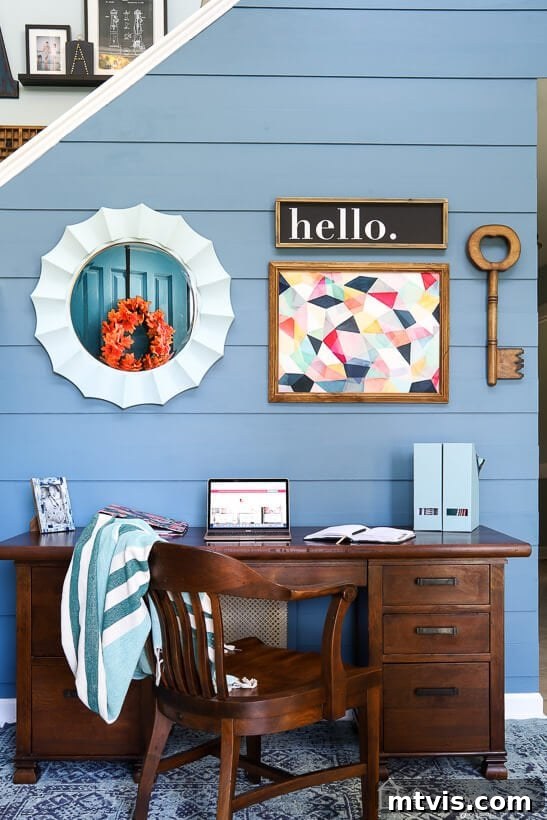 Finished modern DIY plank wall in Behr Blueprint, featuring a sleek desk setup in the foyer.