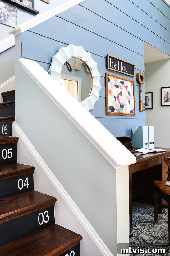 Modern foyer with plank wall, a minimalist desk, and thoughtful decor.