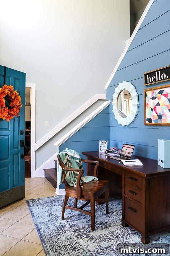 Detailed view of the desk area in the modern plank wall foyer, showcasing functionality.