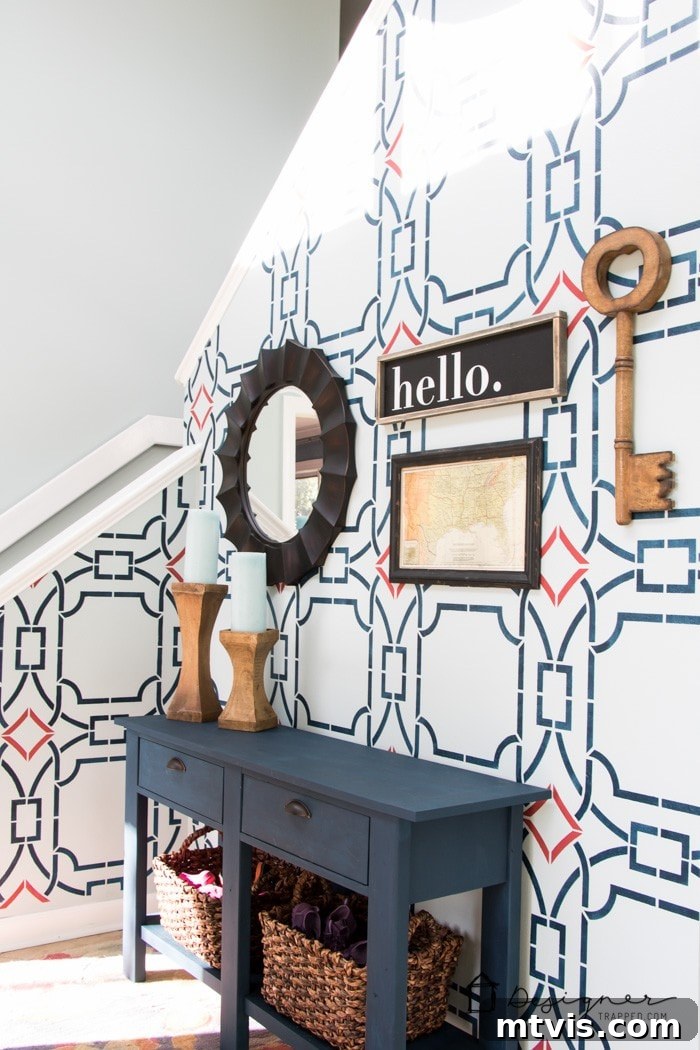 Before photo of a stenciled foyer wall with a decorative console table.