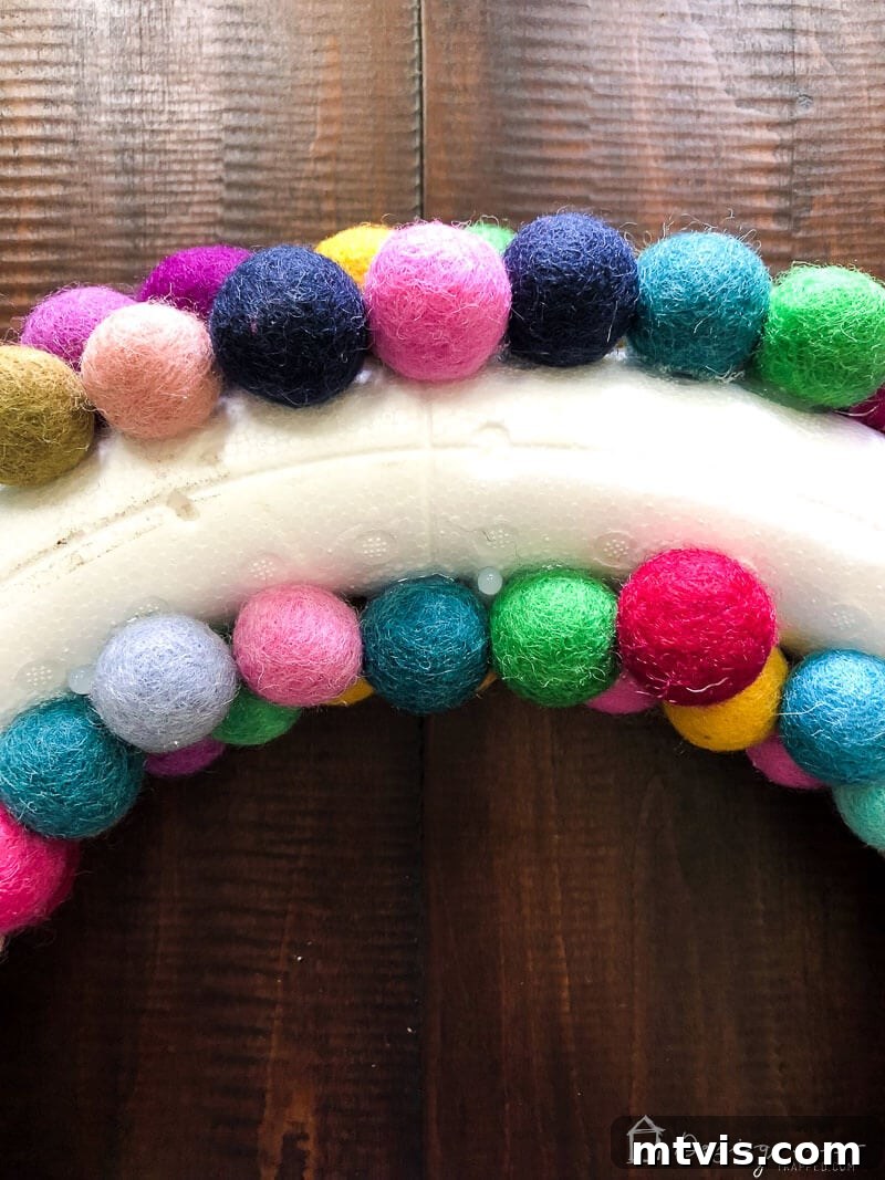 Vibrant Felt Ball Wreath Project 8 The neatly covered back view of the felt ball wreath, showing how the felt balls cover the edges and sides but leave the flat back exposed for hanging.