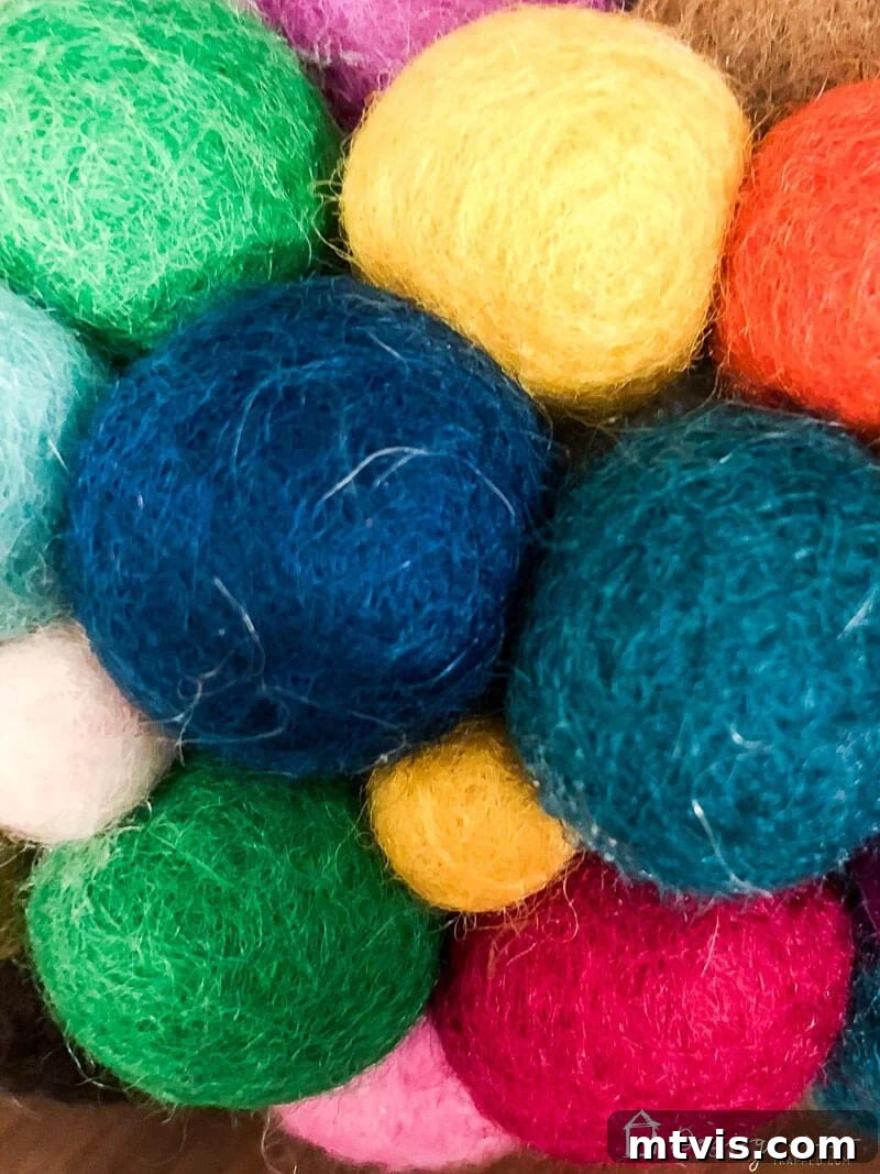 Vibrant Felt Ball Wreath Project 9 A close-up view of the felt ball wreath, highlighting the intricate texture and vibrant colors, with smaller felt balls meticulously filling any gaps for a seamless finish.