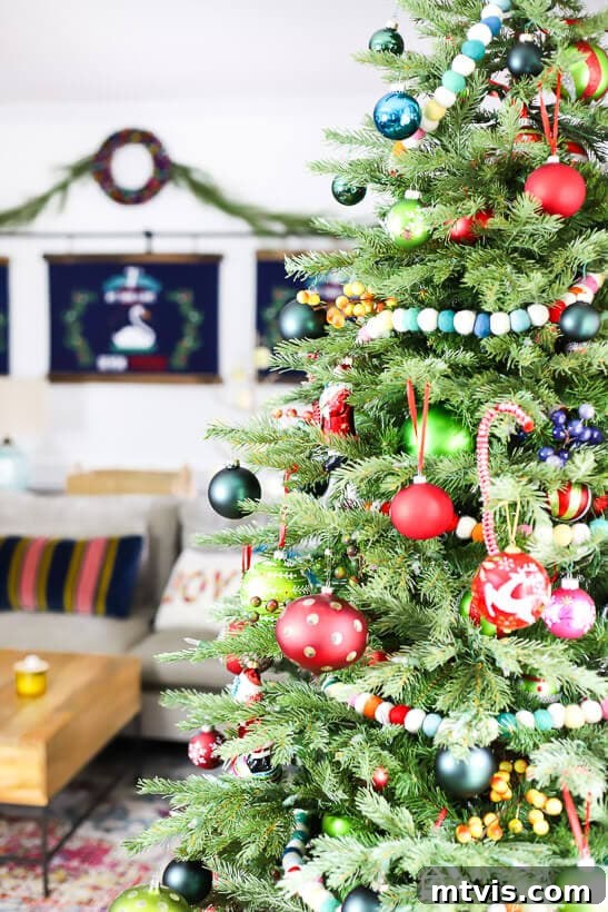 My Technicolor Tannenbaum 4 Detail shot of an eclectic Christmas tree showcasing unique, handcrafted, and brightly colored ornaments against green branches.