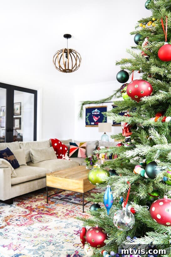My Technicolor Tannenbaum 8 A beautifully decorated living room for Christmas, featuring the vibrant and eclectic Christmas tree as the focal point, surrounded by cozy holiday decor.