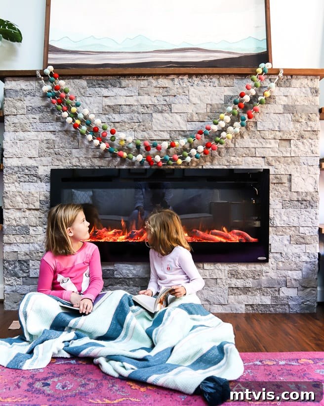 pompom garland over fireplace in bedroom, adding festive color
