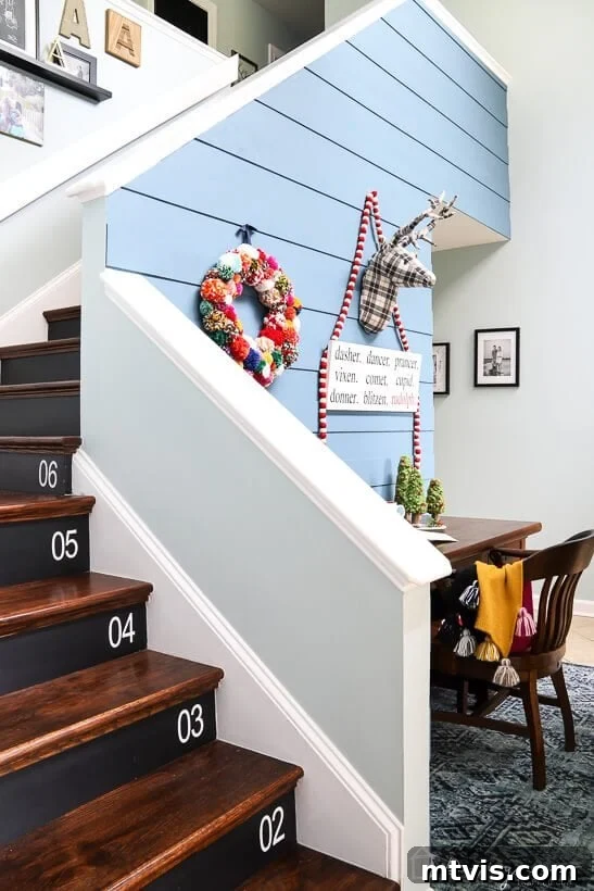 colorful Christmas decor in entryway with plaid stag