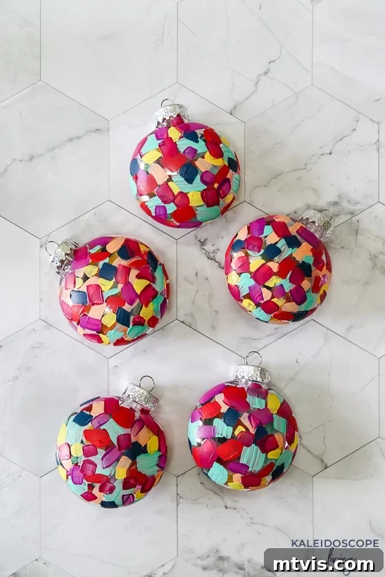 Craft Your Own Hand-Painted Christmas Ornaments 9 A collection of colorful hand painted Christmas ornaments arranged together.