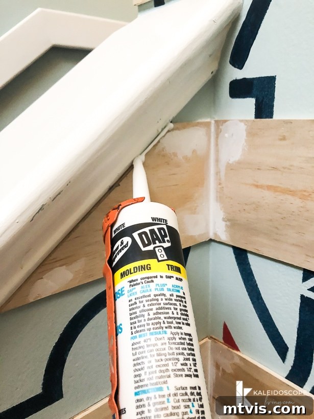 Caulking Made Easy A Beginner's Guide 6 A close-up of how to caulk, using a DAP bottle caulking the edges of a plank wall.