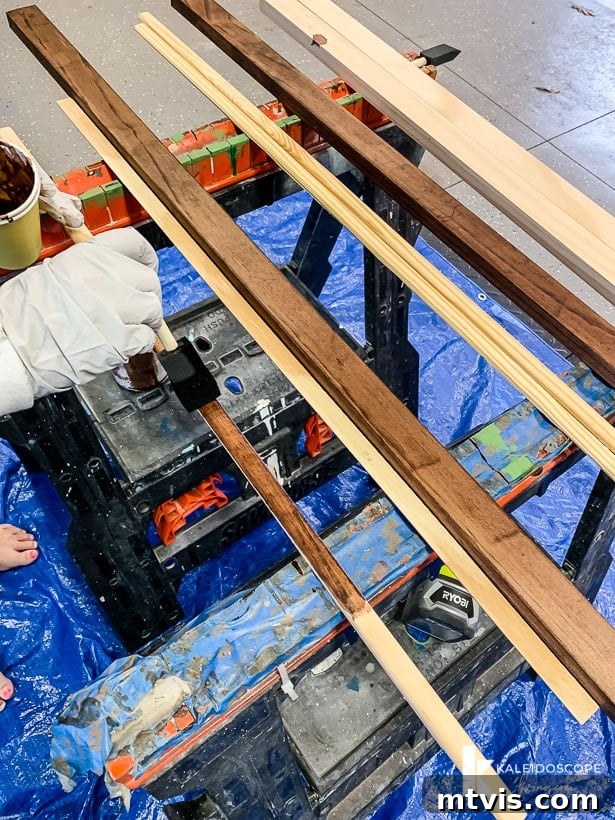 DIY Oversized Frames Stunning Decor Under $20 6 Sanding and staining wood for DIY picture frames.