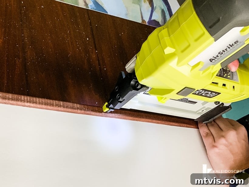 DIY Oversized Frames Stunning Decor Under $20 9 Close-up of screen molding securing print in DIY frame.