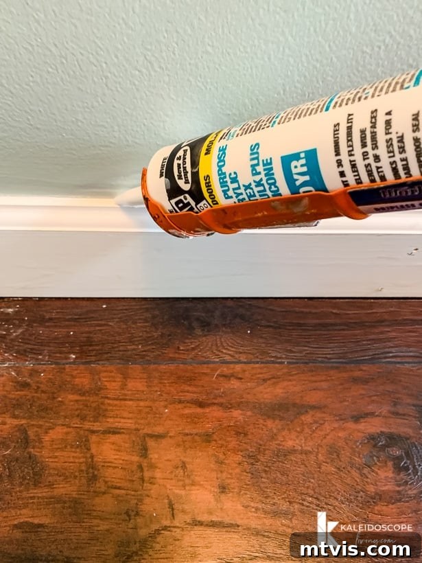 DAP Alex Plus caulking along baseboard