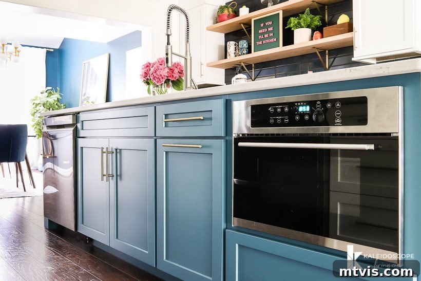 large teal kitchen island painted in Silken Peacock by Sherwin Williams, serving as a vibrant centerpiece