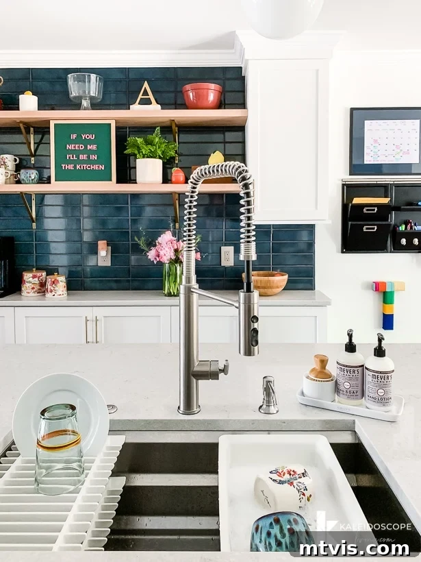 kohler prolific sink in white and teal kitchen, demonstrating its perfect integration