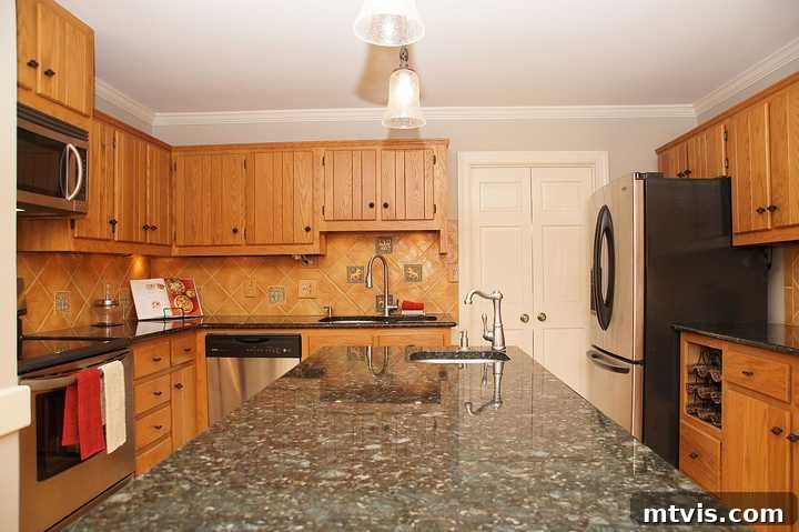 orange oak cabinets in outdated kitchen, showing a traditional, closed-off layout