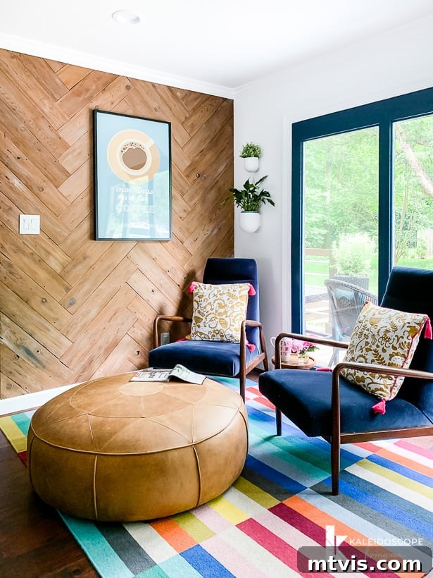 colorful seating area in kitchen with blue velvet chairs and leather ottoman