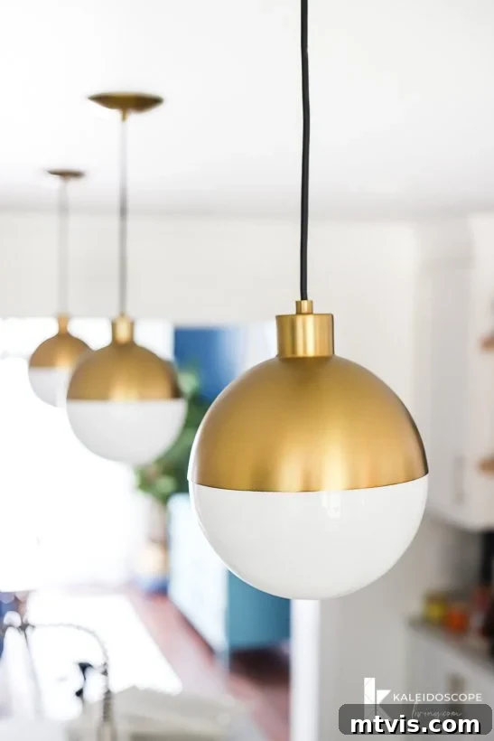 modern gold and white pendant lights in kitchen remodel, adding a touch of elegance