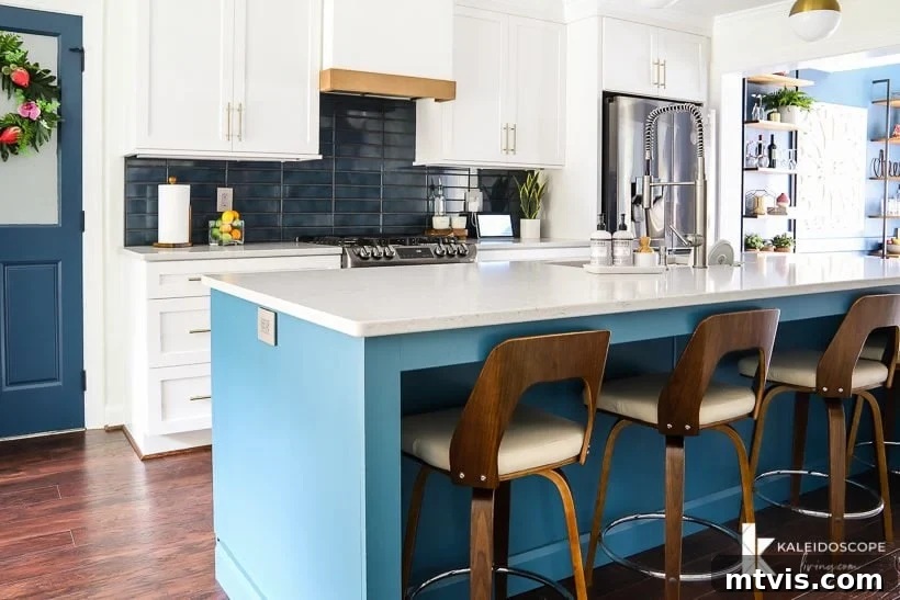white and teal modern kitchen with open layout, featuring a spacious island and sleek design