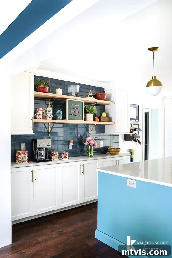 white and teal kitchen open to dining room, emphasizing the seamless flow between spaces