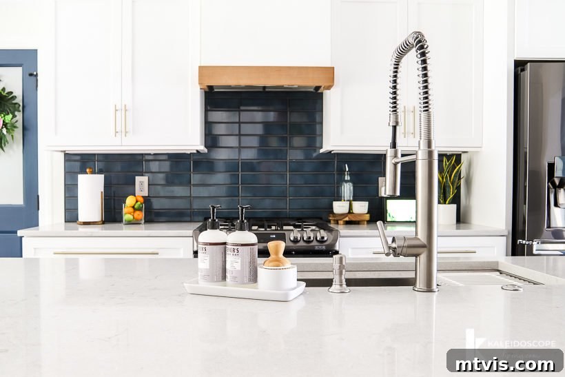 Wood and White Concrete: A DIY Range Hood Transformation 2 Stunning white kitchen with navy blue tile backsplash and a custom DIY concrete and wood range hood