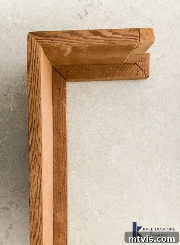 Wood and White Concrete: A DIY Range Hood Transformation 10 Detailed construction of the wood accent for a DIY range hood finish, showing precise cuts and joining