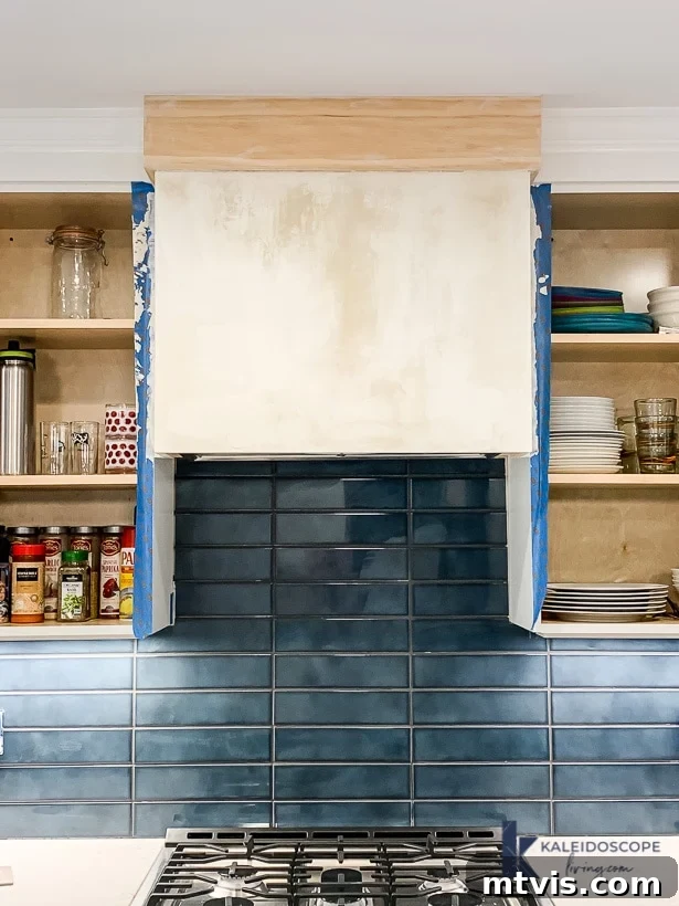 Wood and White Concrete: A DIY Range Hood Transformation 9 Second layer of white skimcoat concrete drying on the range hood, showing a typical splotchy appearance before final coats and sanding