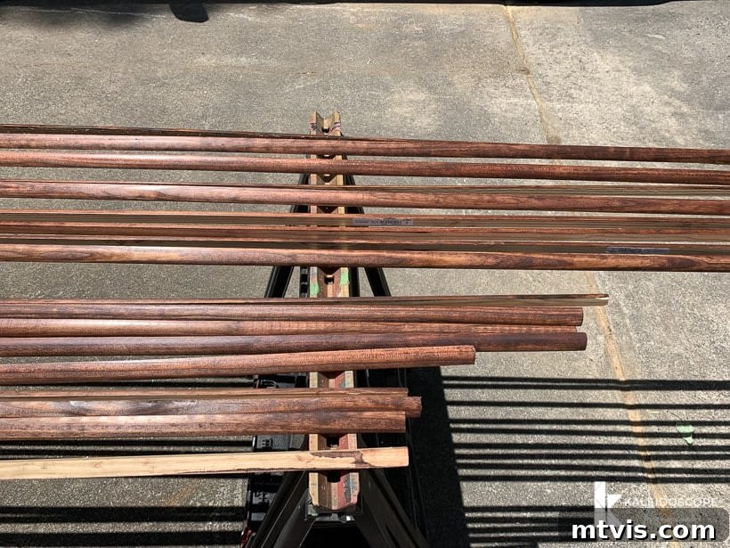 DIY Quarter Round Molding Installation 3 A sawhorse outside holds lines of stained quarter round molding trim, drying after application.