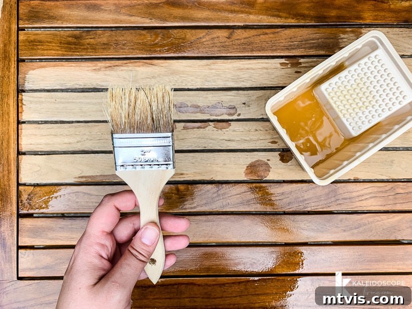 Revitalize Your Teak: A 4-Step Guide 12 Applying teak oil to an outdoor table during restoration