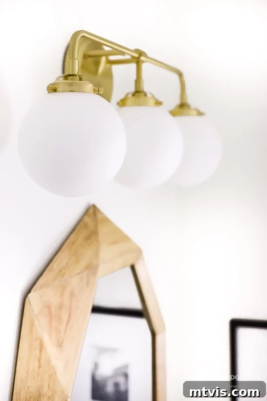 Handmade Hues: Our Vibrant Bathroom Makeover 11 Satin brass vanity light from Build.com, adding modern elegance to the powder room.