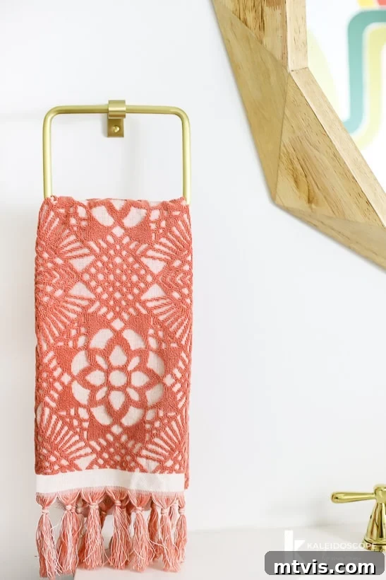 Handmade Hues: Our Vibrant Bathroom Makeover 12 Colorful details in a modern powder room, including a satin brass towel bar and toilet paper holder.